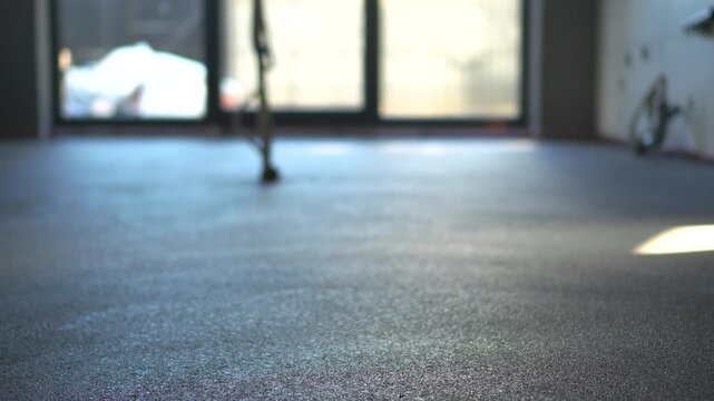Highly engaging commercial ready panning shot from right to left of a freshly poured cement screed floor in a modern construction site.