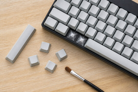 Keyboard keycaps cleaned with a small detail brush