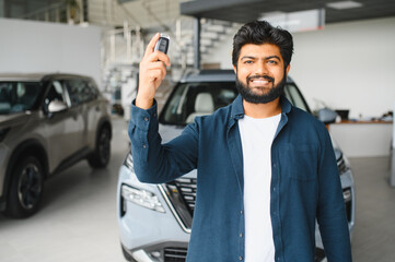 Happy indian man holding new car keys