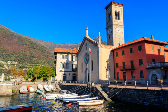 Small harbor and Church of Santa Tecla in Torno, picturesque village on the Lake Como, Lombardy, Italy
