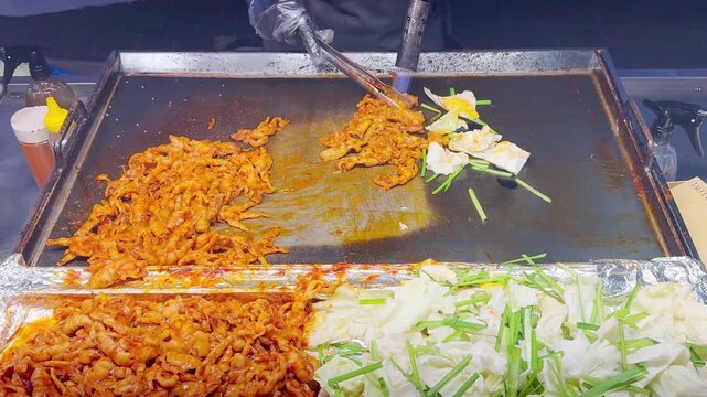 Korean Street Food &ndash; Spicy Stir-Fried Chicken Feet with Red Chili and Fresh Cabbage at Myeongdong Night Market in Seoul