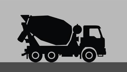 Fototapeta premium Bold black silhouette of a concrete mixer truck driving on a gray surface against a light gray sky backdrop.