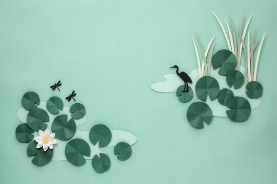 Handcrafted paper art depicting a serene pond ecosystem with elegant water lilies, soaring dragonflies, and a graceful heron, embodying tranquility and natural beauty
