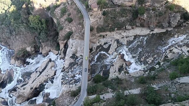 Aerial view of the bridge over the canyon in Constantine. Car crosses the iver