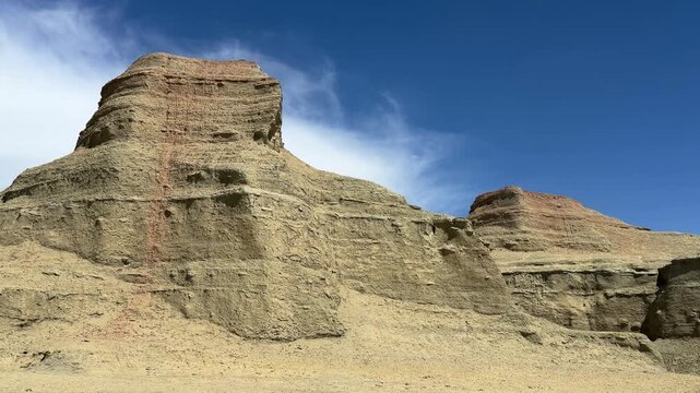 Majestic Yardang landform of Urho Ghost City under a dramatic cloudy sky in Karamay, Xinjiang, China.