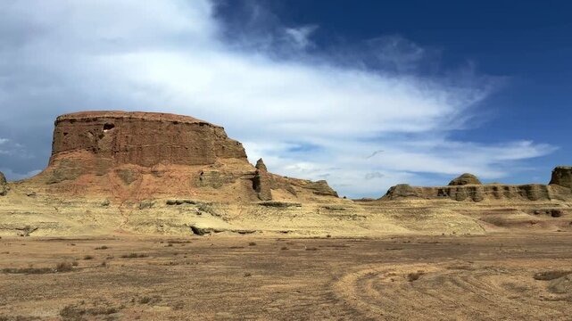 Majestic Yardang landform of Urho Ghost City under a dramatic cloudy sky in Karamay, Xinjiang, China.