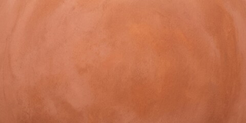 Fototapeta premium terracotta plaster texture background, warm orange clay wall surface with subtle grain, minimalist rustic plaster backdrop for interior design.
