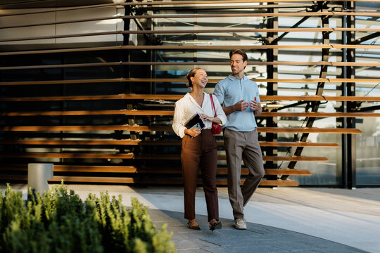 Joyful stroll under modern architecture with a delightful couple