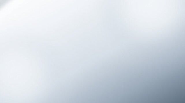 Bright white bokeh circles on soft grey abstract background. 4K Video