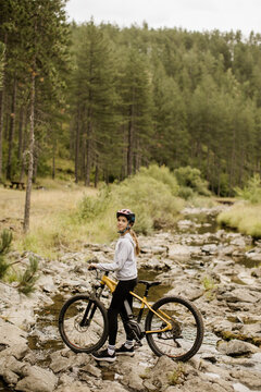 Exploring serene trails with a mountain bike by the flowing stream