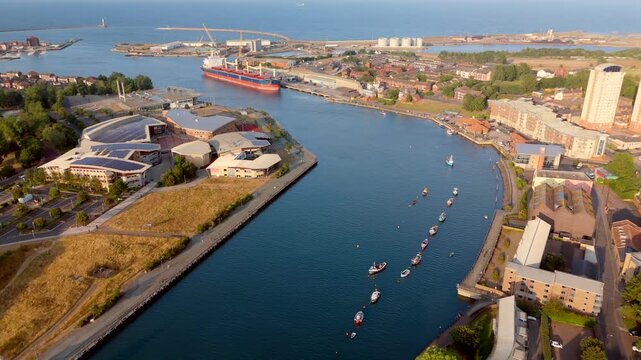 Sunderland UK: 17th July 2026: Drone vertical pan of Sunderland River wear and Port at golden hour. Wearmouth Bridge and the Monkwearmouth Railway Bridge at sunset