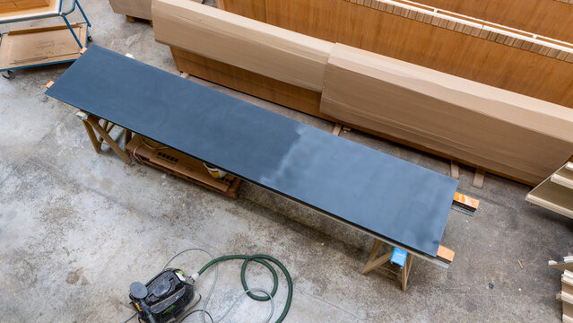 Dark countertop on trestles in a joinery workshop