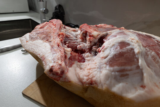 Raw Pork Leg Deboning in a Home Kitchen: Hands, Knife, and Realistic Meat Processing