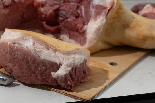 Raw Pork Leg Deboning in a Home Kitchen: Close-Up Butchering Process