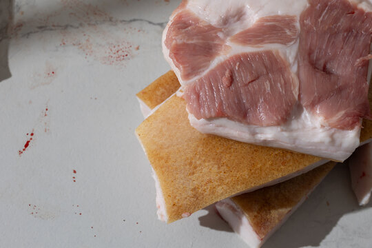 Raw pork leg slab in a home kitchen: unpolished meat texture and documentary realism