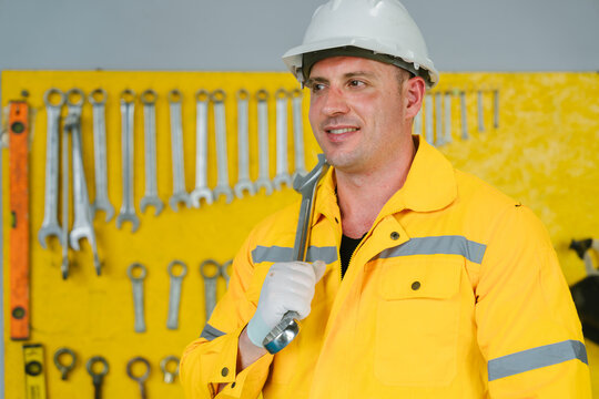 Engineers work conceptual framework for industrial engineering factory work joyful cheerful professional adult male smiling holding tool wrench