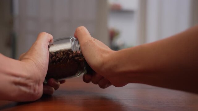 POV close up of woman hands straining to twist tight coffee jar cap, vision blurring from physical overexertion before giving up, struggle concept.