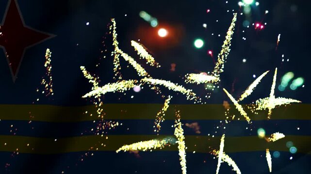 Bright golden fireworks exploding in the night sky over the national flag of Aruba