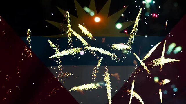 Bright golden fireworks exploding in the night sky over the national flag of Antigua and Barbuda