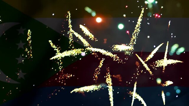 Bright golden fireworks exploding in the night sky over the national flag of Comoros