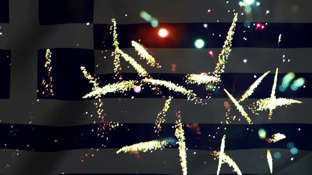 Bright golden fireworks exploding in the night sky over the waving national flag of Greece