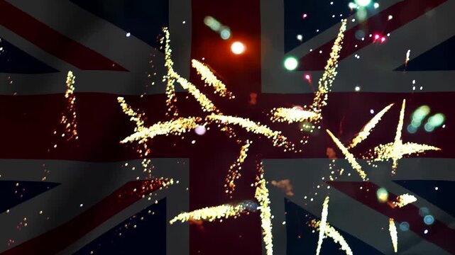 Bright golden fireworks exploding over the national flag of the united kingdom celebrating national event