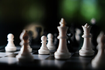 Chess piece on black and white board, strategic game scene with dramatic lighting and shallow depth of field © CoreRock