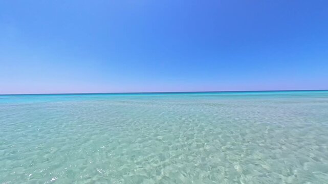 Immersive POV eye level of Mediterranean sea with gentle waves and color gradients from white to deep azure