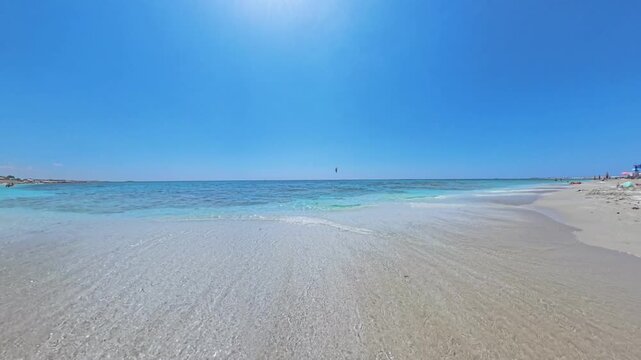 Walking POV along pristine Mari Ermi beach Sardinia with quartz sand and turquoise Mediterranean water