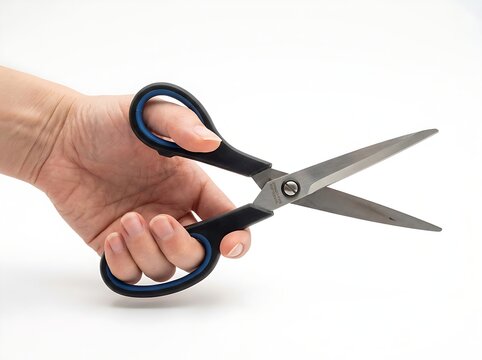 Close up of hand holding open stainless steel craft scissors isolated against a clean white backdrop.
