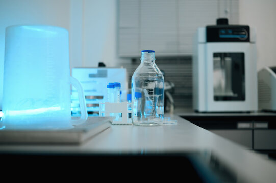 Scientific Laboratory Bench with Glass Bottle, Test Tubes and Blue UV Light Equipment