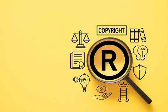 Magnifying glass focusing on a registered trademark R symbol, surrounded by copyright, patent, and legal protection icons on a yellow background. Concept of intellectual property and brand ownership.