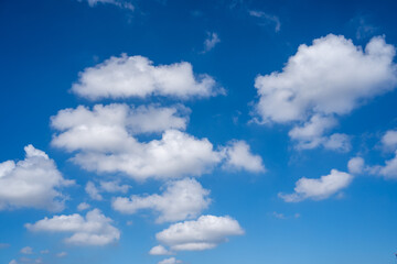 Fototapeta premium White Fluffy Clouds Scattered in Clear Deep Blue Sky