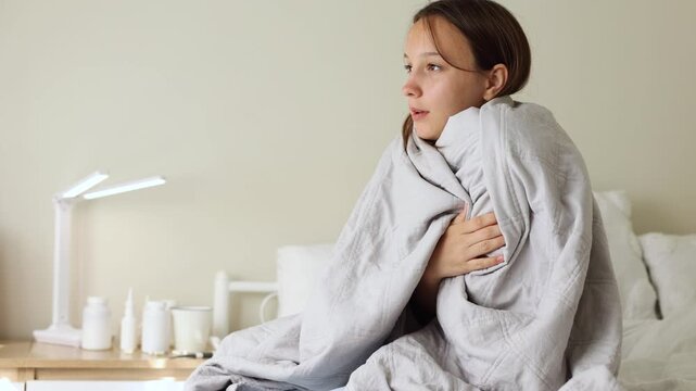 Sick girl with runny cold symptoms resting at home, representing illness, flu and seasonal infection