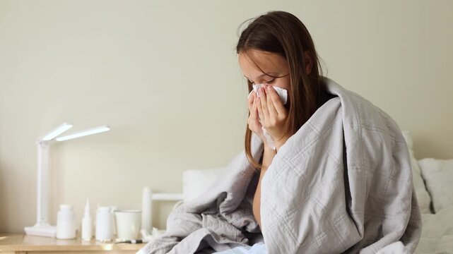 Sick girl with runny cold symptoms resting at home, representing illness, flu and seasonal infection