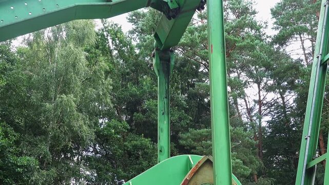 Oil pumpjack extracting crude oil from a well. Close up of a pump working in a forest in lower saxony, northern germany