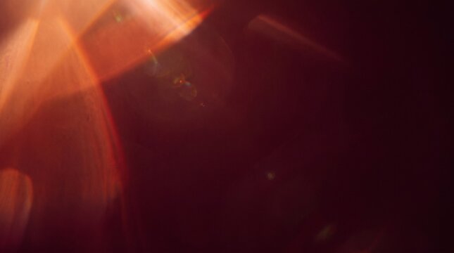 Orange Red Light Leaks Creating Warm Cinematic Glow Across Dark Abstract Background
