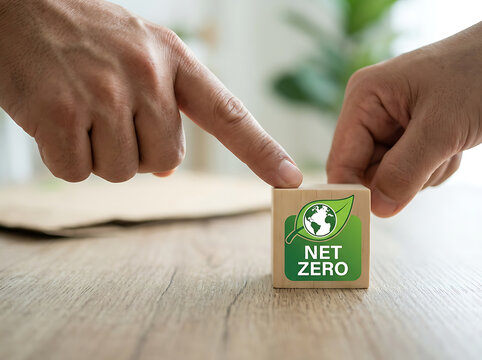 Person pointing at net zero wooden block