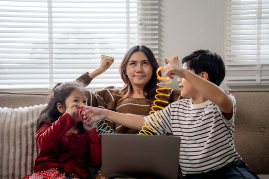 Stressed mother dealing with noisy children while working from home