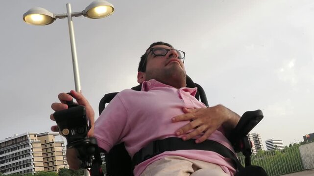 Low angle view of man with disability driving electric wheelchair