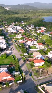 Florian&oacute;polis, Daniela Beach. Aerial View of Tropical Coastline. Establishing Shot. Santa Catarina, Brazil. Vertical video