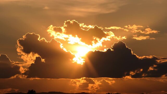 Sunset over ocean with dramatic clouds and sun rays breaking through for a hopeful concept