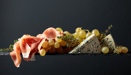 Fototapeta premium Grapes with blue cheese, prosciutto and thyme.