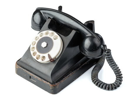 Vintage black phone isolated on a white background.