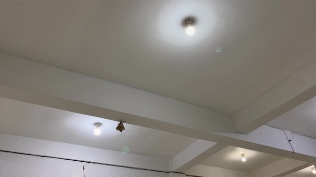 Simple room ceiling architecture with glowing ceiling light fixture