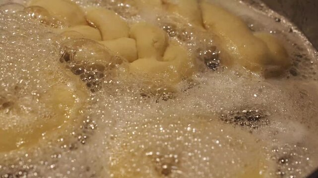 Golden Brown Dough Frying in Bubbling Hot Oil Crispy Texture Macro Shot Dynamic Cooking Process for Culinary Content 4K Video