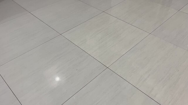 Modern marble tiles floor background with subtle reflections