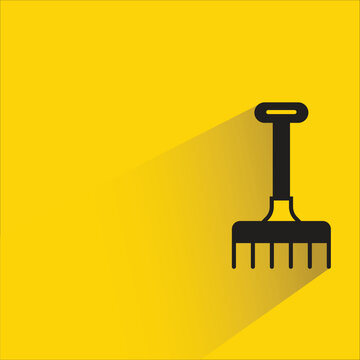 rake tool icon with shadow on yellow background