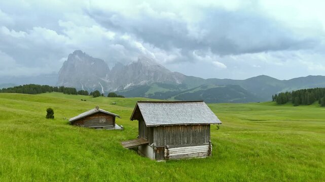 Drone View of Shepherd Huts at Alpe di Siusi Under Dramatic Sky
