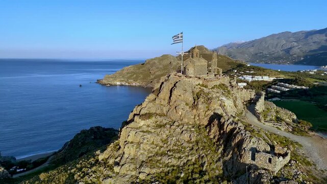 Drone Orbit Around Greek Chapel on Coastal Cliffs in Crete
